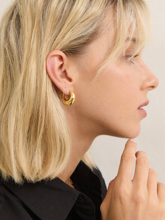 Lustre & Sage Porte Hoop gold earrings on model, angled view.