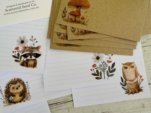 Set of stationery items with animal illustrations on a wooden surface