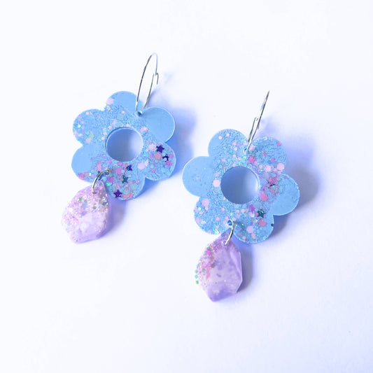 Handmade blue flower and purple leaf resin hoop earrings with glitter.