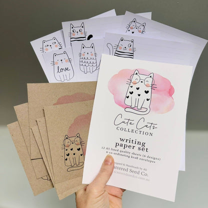 Cute Cats Collection writing paper set featuring 12 A5 lined sheets with whimsical cat illustrations in 6 designs, and 6 coordinating kraft envelopes. Handcrafted by Scattered Seed Co.