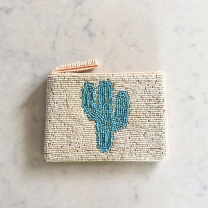 Hand beaded coin purse with a blue cactus design on a marble surface