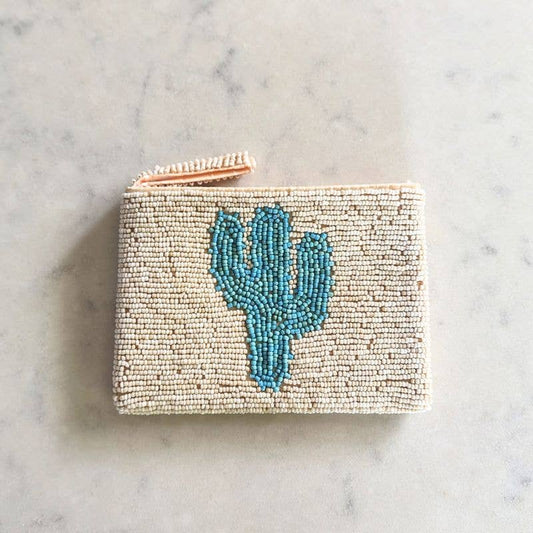Hand beaded coin purse with a blue cactus design on a marble surface