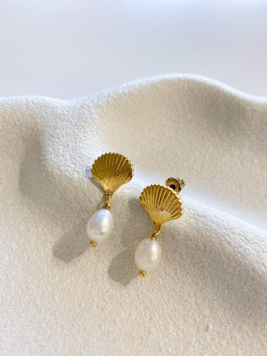Clamshell Pearl 18K gold plated earrings on white surface.