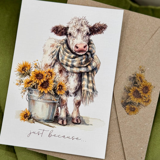 Card with a cow illustration wearing a scarf, surrounded by sunflowers, on a green background.