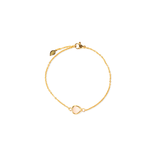 A delicate gold chain bracelet featuring a small, pale pink glass stone inlay, shown on a plain white background.