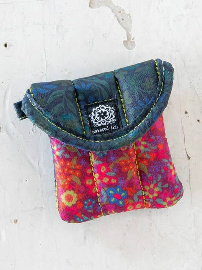 Colorful fabric pouch with floral pattern on a white background