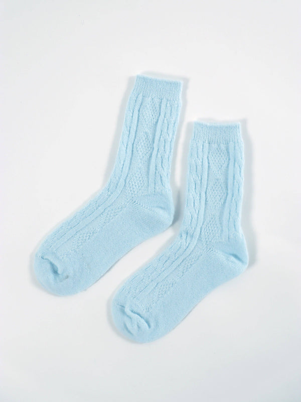 Pair of light blue socks on a white background