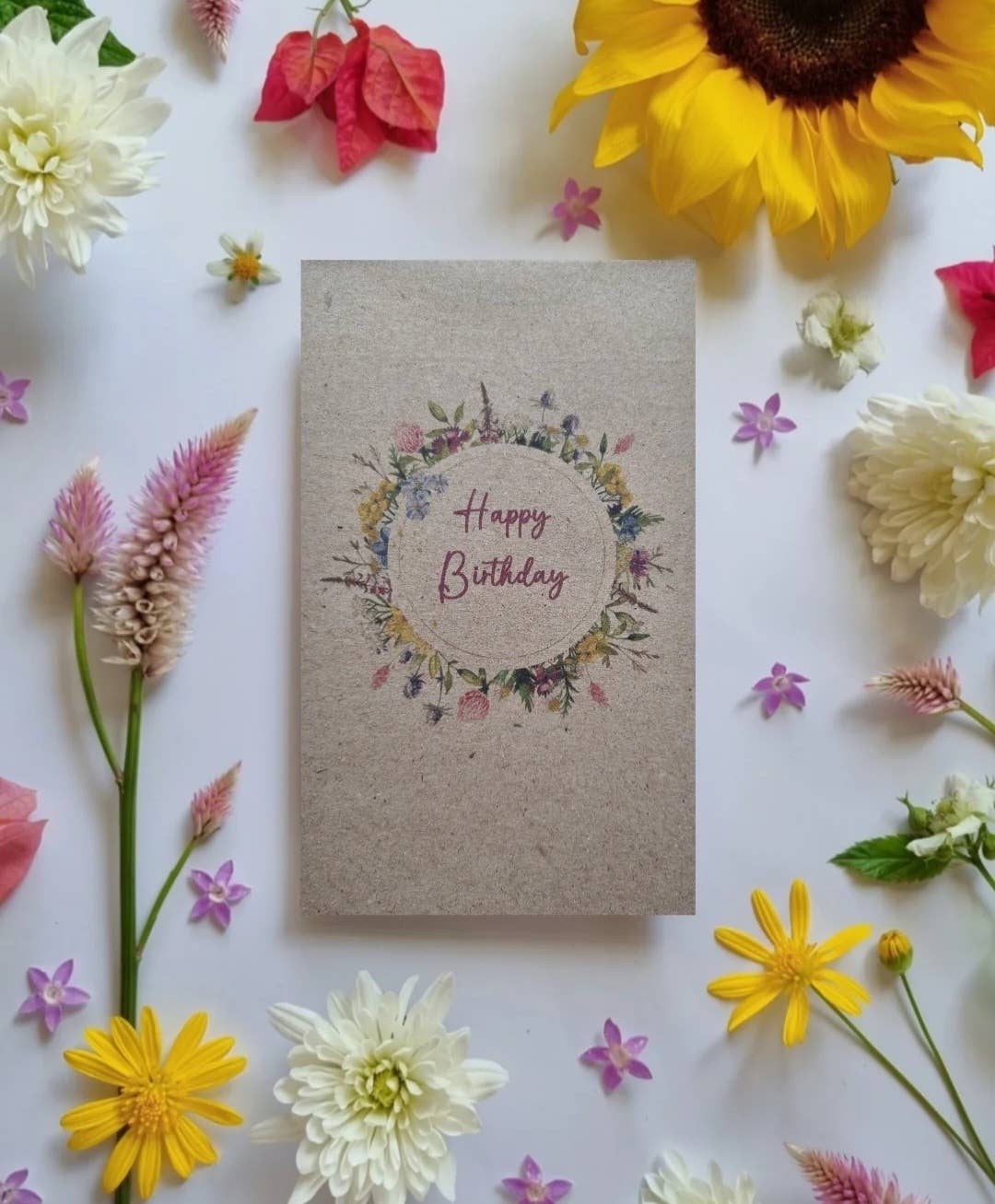 Packet of flower seeds featuring an illustration of a wreath of pretty flowers and 'Happy Birthday' written inside it.