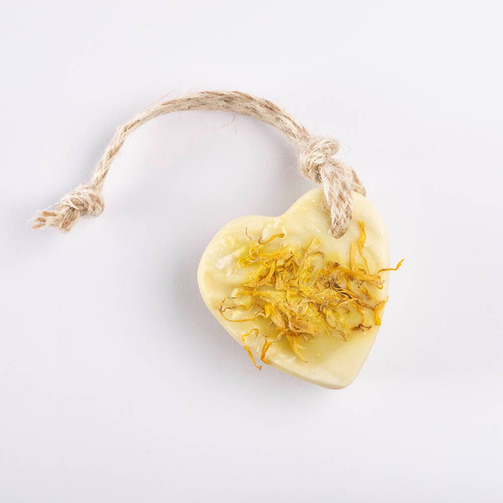 Heart-shaped lemon myrtle and lemongrass soap with a softy yellow tone, threaded with natural jute and surrounded by dried citrus for a fresh, handmade touch.