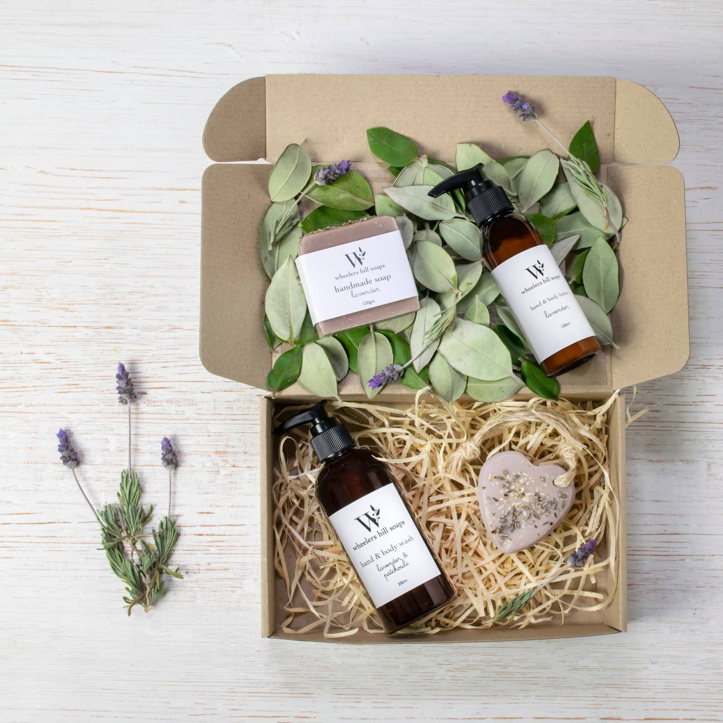 Lavender gift set by Wheelers Hill Soaps with soothing wash, lotion, soap bar, and heart soap in kraft gift packaging with natural touches.