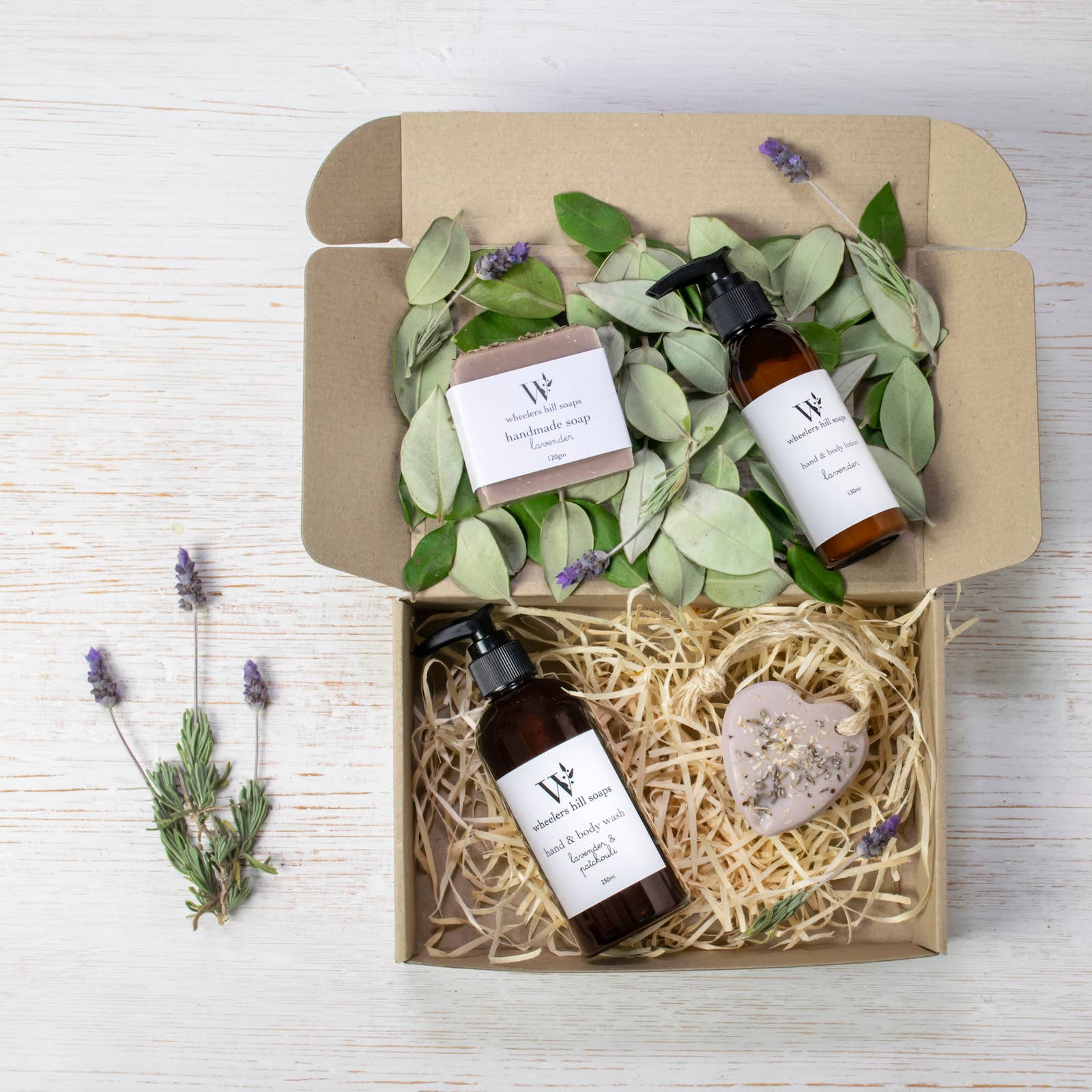 Lavender gift set by Wheelers Hill Soaps with soothing wash, lotion, soap bar, and heart soap in kraft gift packaging with natural touches.