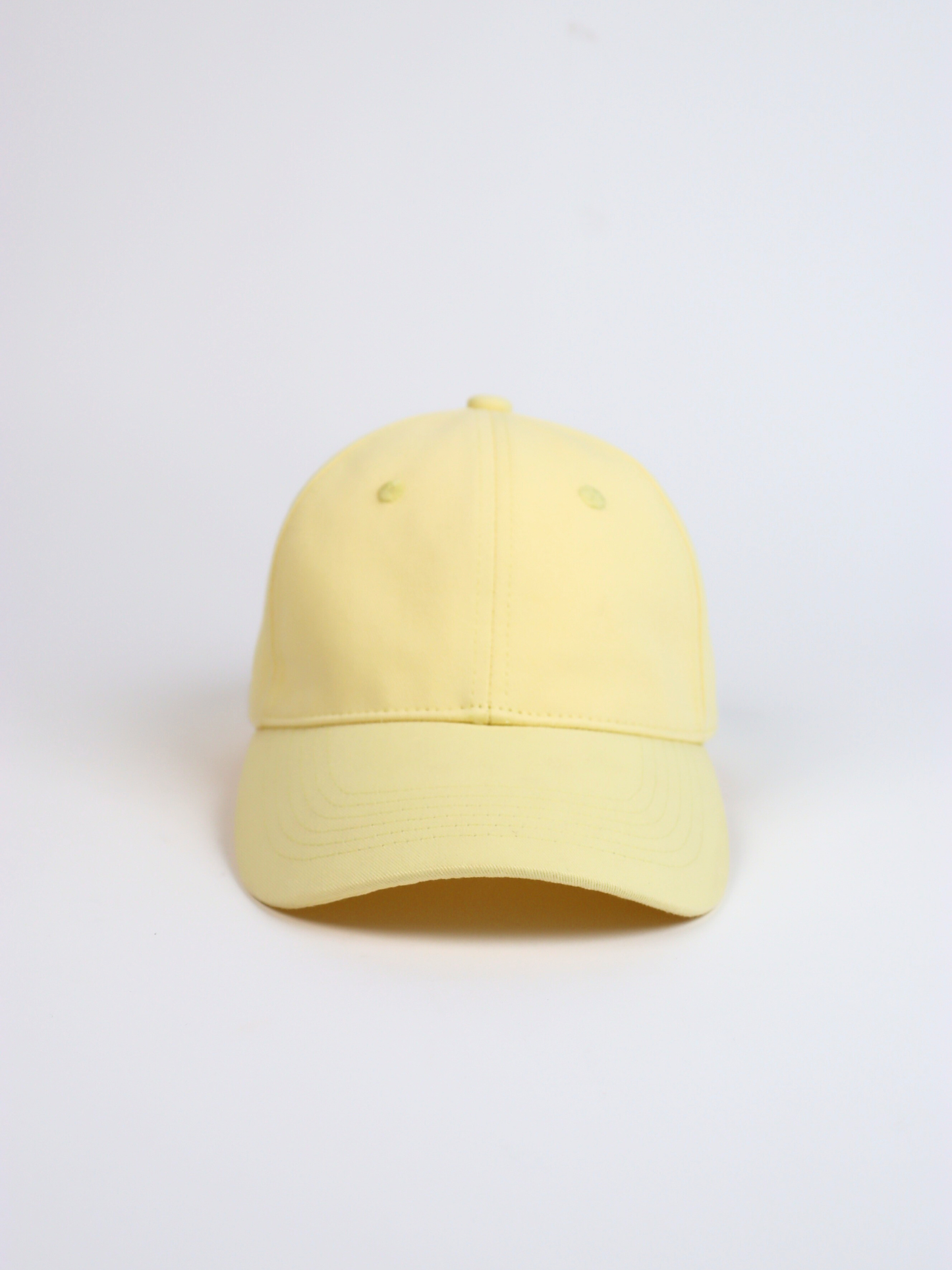 Yellow  adjustable baseball cap on a light gray background