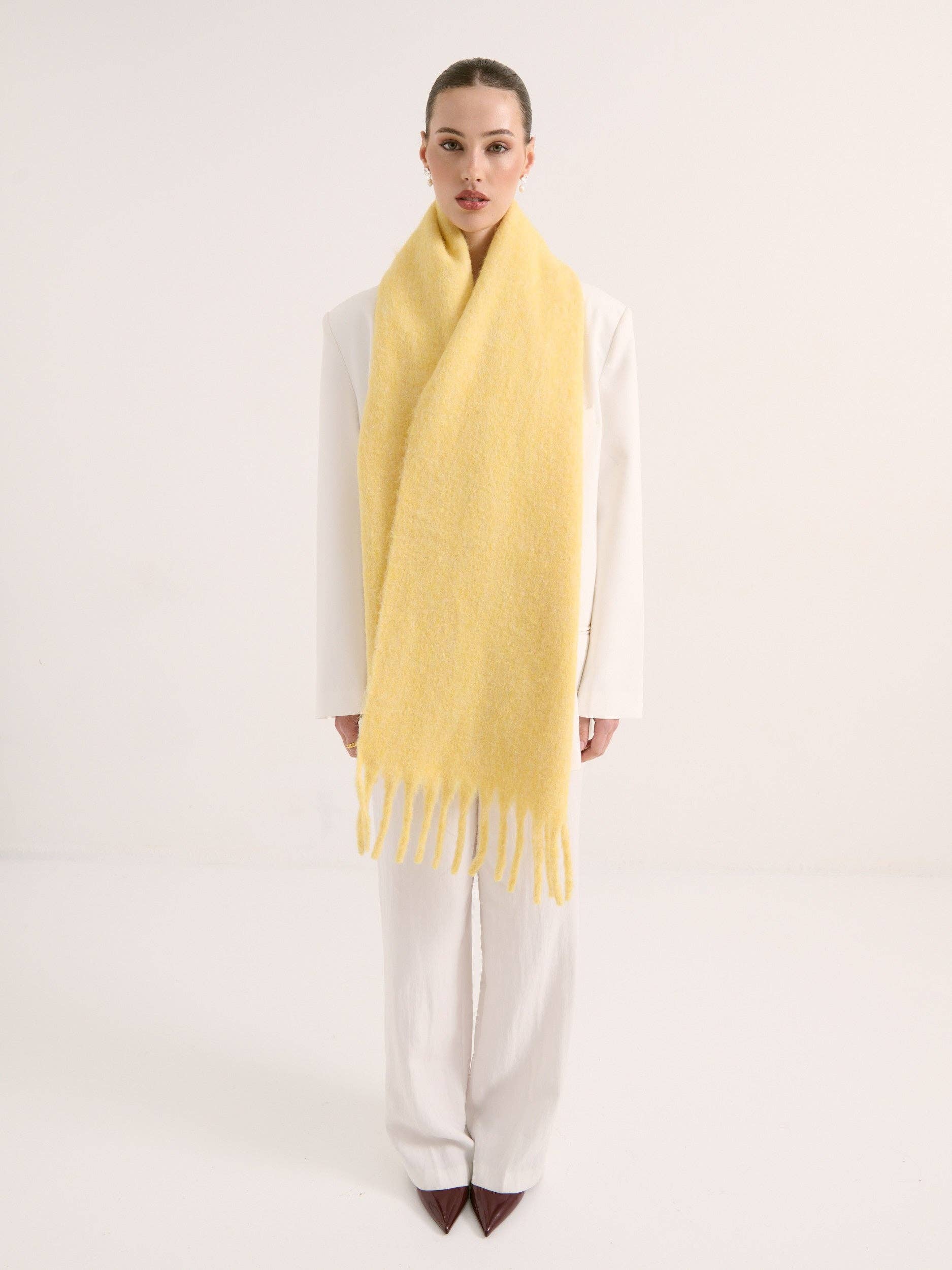 Woman wearing a yellow scarf on a white background