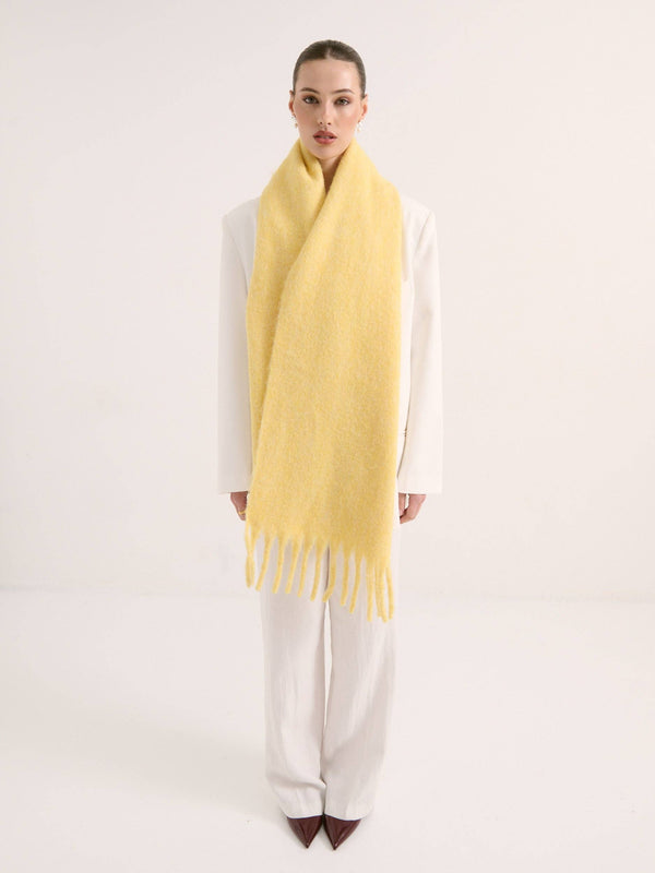 Woman wearing a yellow scarf on a white background