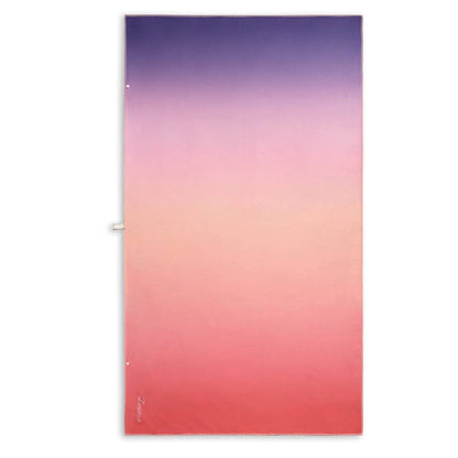 Sand free towel with a lagoon sunset inspired design. A gradient from soft purple haze to rich magenta, fading into bold red, capturing a shift from cool to warm tones.