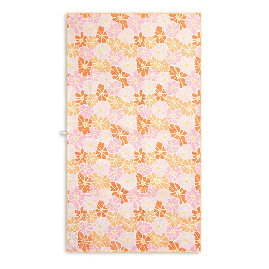 Sand free beach towel featuring a cheerful floral design with red, light orange, and pink flowers, each with yellow centers.