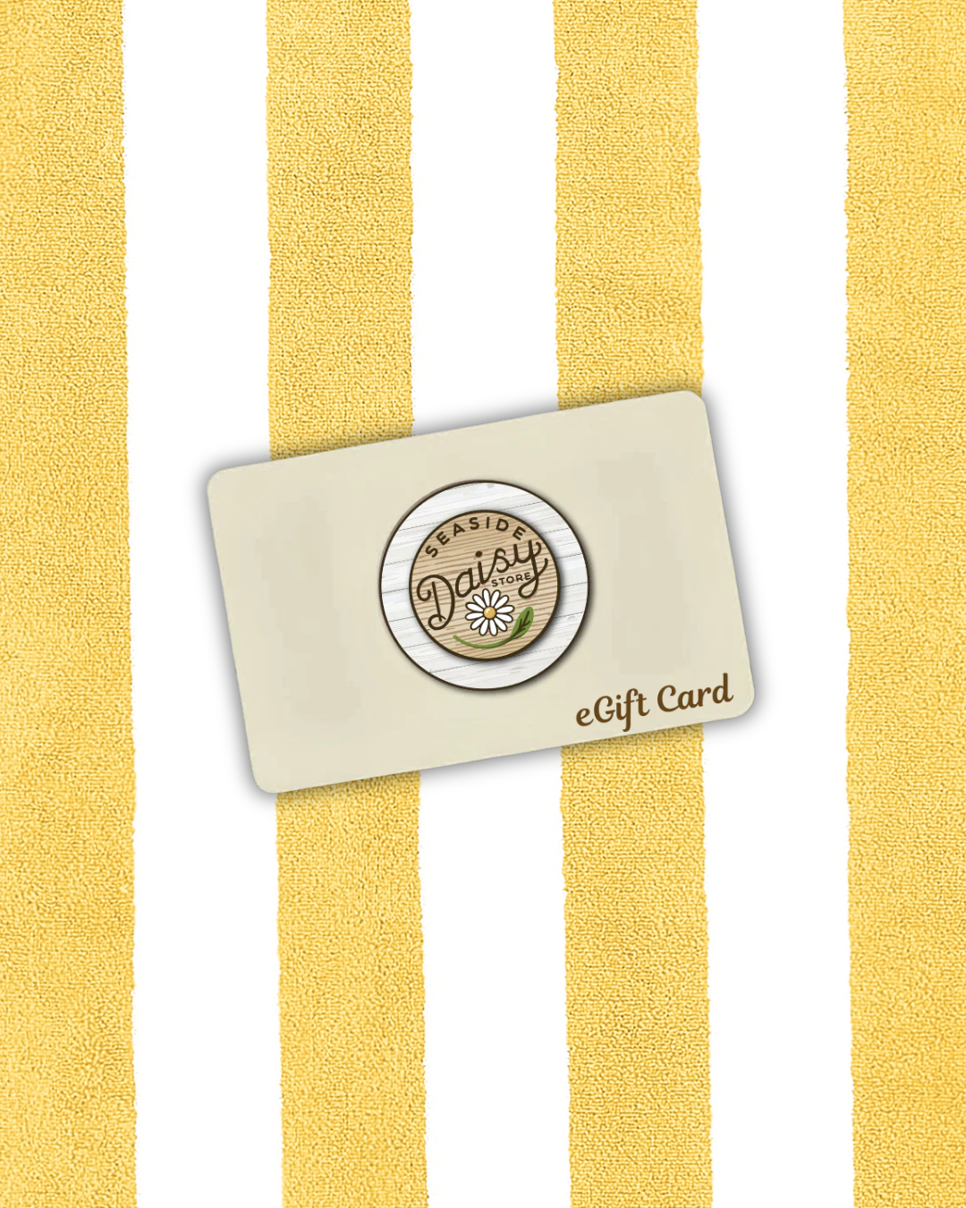 Gift card with a logo (Seaside Daisy Store eGift Card) on a yellow and white striped background beach towel.