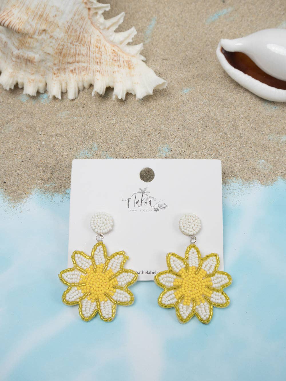 Handcrafted sunflower earrings with white and yellow beaded petals and centres.
