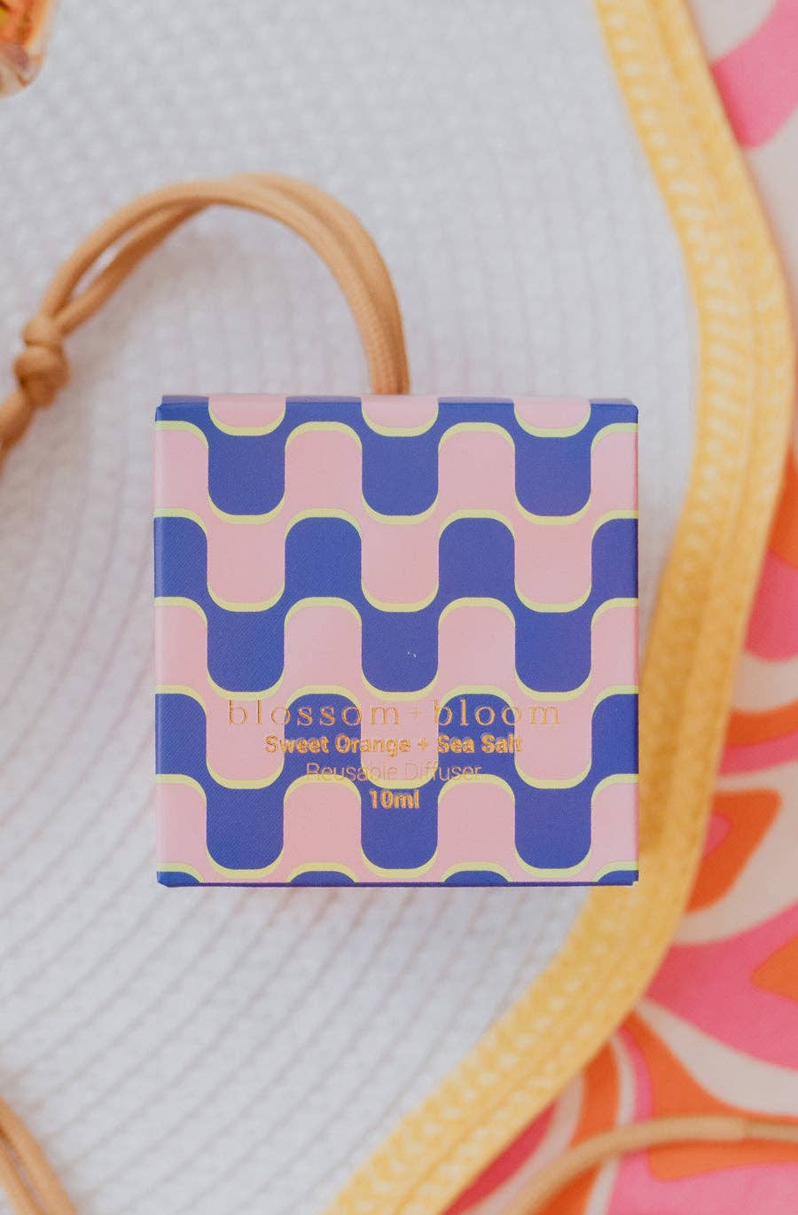 10 ml reusable diffuser with a sweet orange and sea salt scent, packaged in a sleek bottle packaged in a vibrant box.