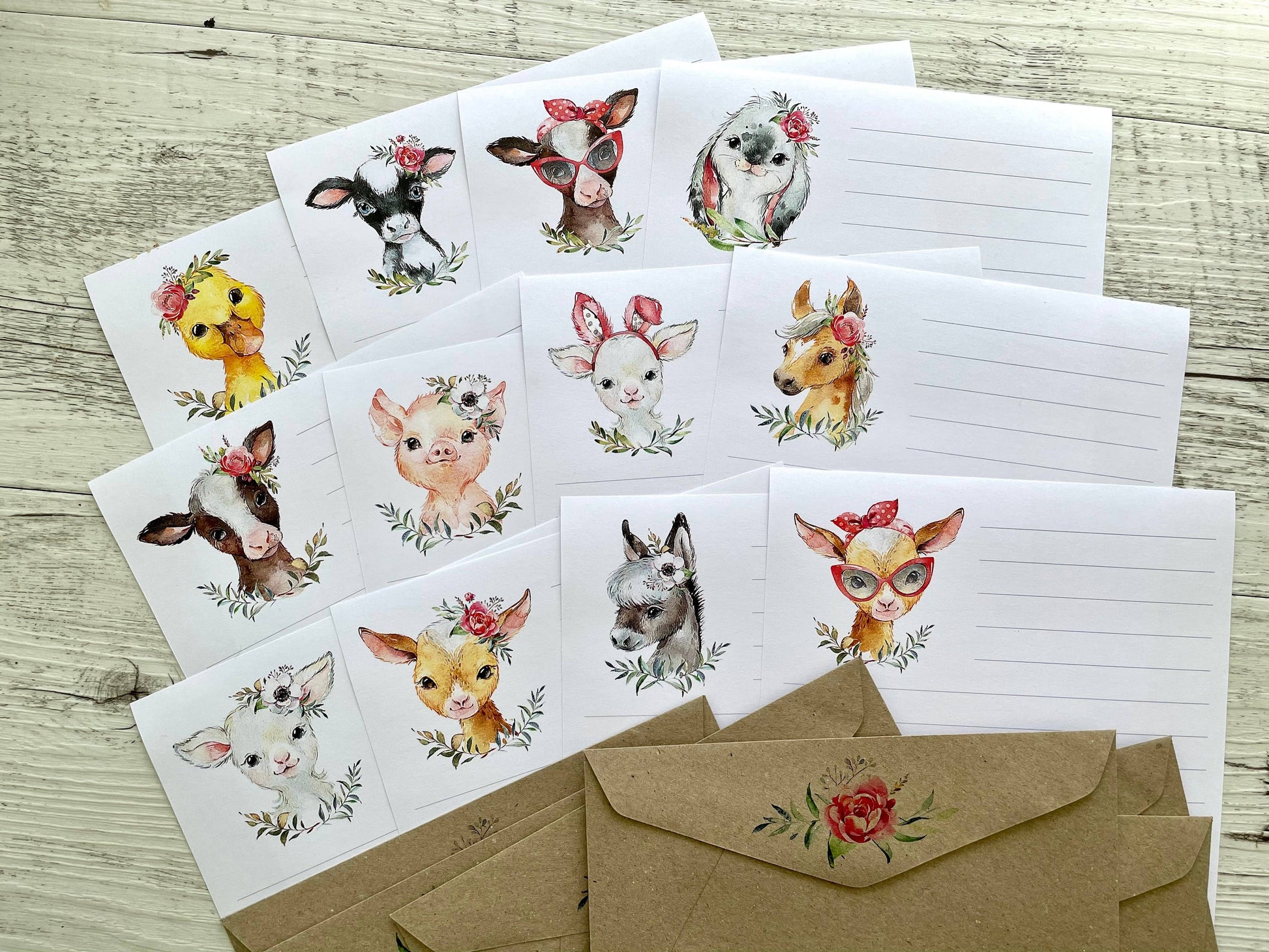 Set of farm animal-themed floral lined writing sheets and envelopes on a wooden surface