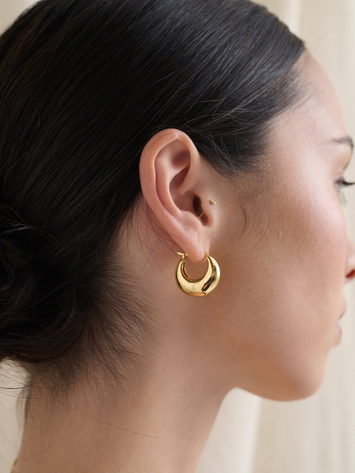 Lustre & Sage gold hoop earrings on model.